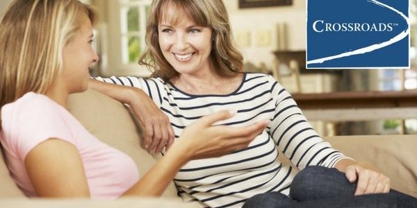 mother talking to daughter on couch about addiction