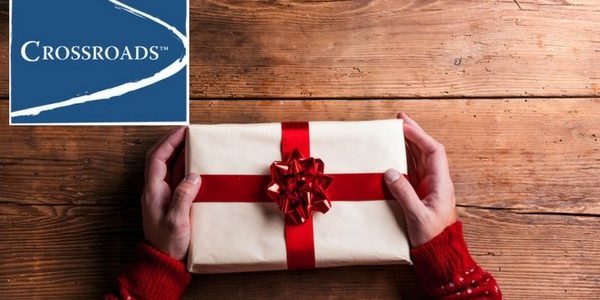 man holding christmas present for a loved one in recovery