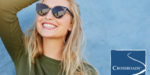 woman smiling in the sun after finding freedom in recovery