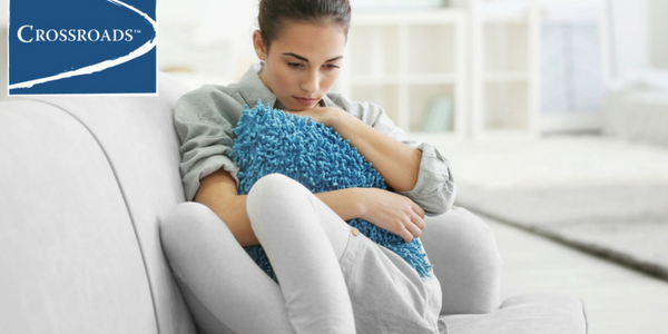 depressed woman on couch ready for treatment for depression and addiction