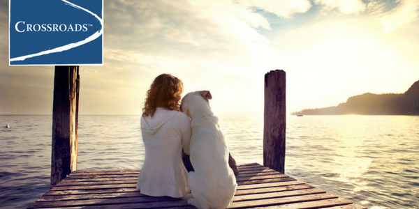 woman with dog on dock showing Gratitude in Addiction Recovery at Crossroads