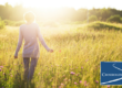 woman walking in field and embracing nature as part of addiction recovery