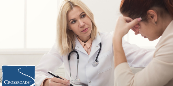 doctor reviewing woman's addiction recovery support system