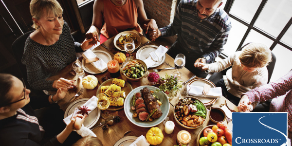 family blessing and support system over holiday meal