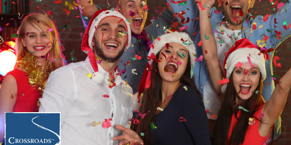 smiling family members at holiday party becoming a stressor in recovery