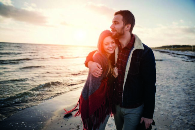 Falmouth_Cumberland_Crossroads husband hugging smiling wife during walk on beach after recovery from mental health and substance use at Crossroads