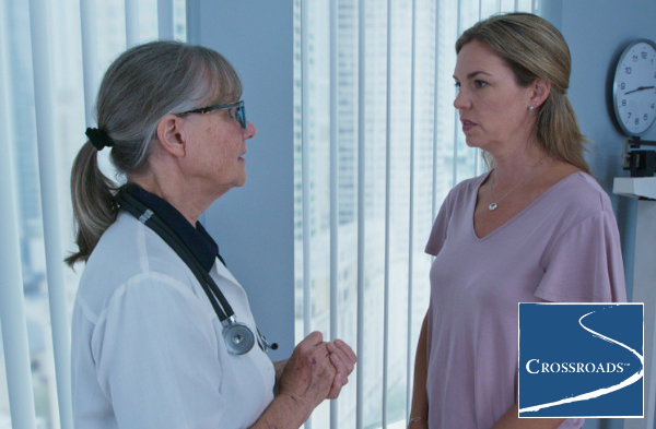 woman consulting doctor about the factors to consider when choosing a drug rehab center for her son