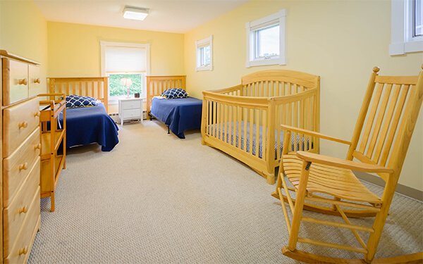 bedroom with cribs at rehab for women with children house