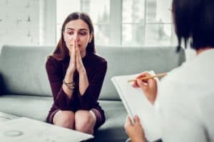 woman contemplating and understanding substance use disorders at therapy