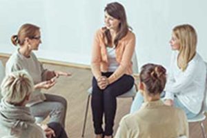 woman sitting in a circle talking at anorexia treatment center
