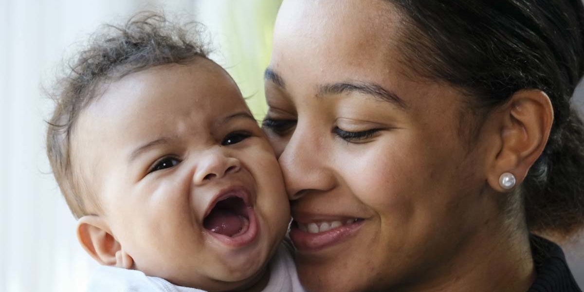 being-a-mom-in-recovery a woman hugs her child as she considers being a mom in recovery
