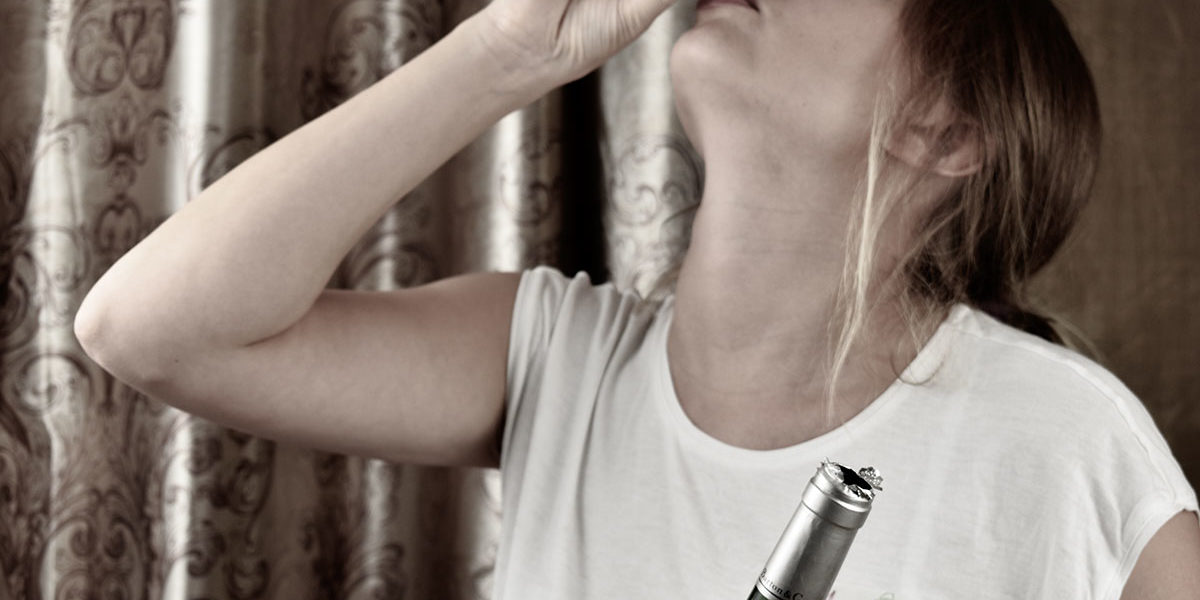 dangers of alcohol addiction a woman drinks and thinks about the dangers of alcohol addiction