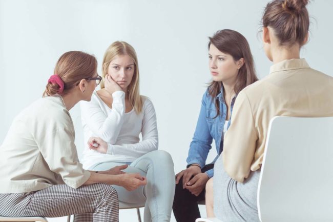 importance-of-gender-specific-treatment a group of women discuss the importance of women's addiction treatment