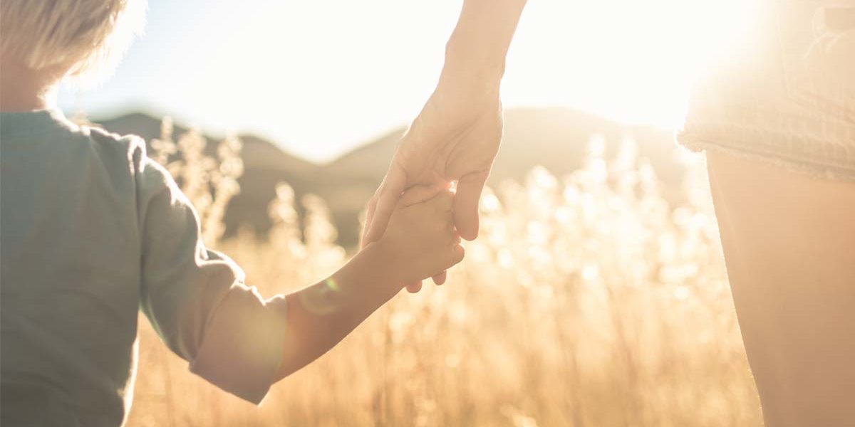 a woman and her child walk toward addiction treatment for moms