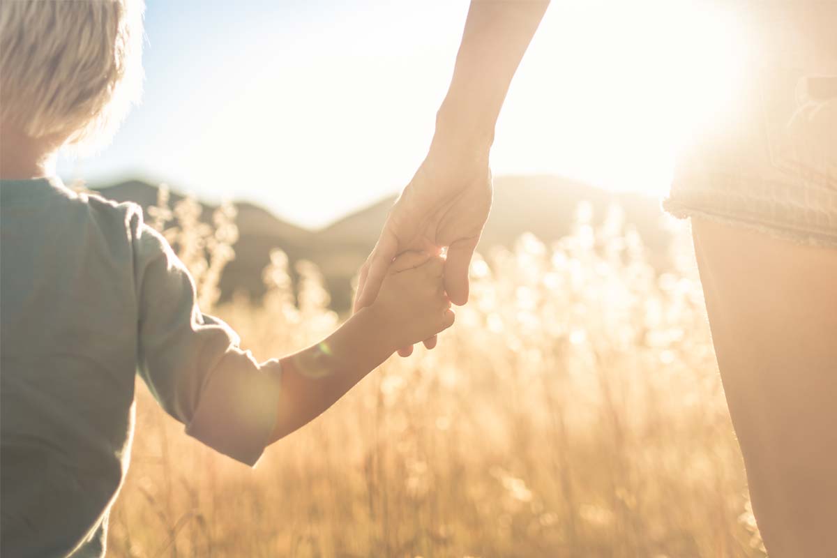 a woman and her child walk toward addiction treatment for moms