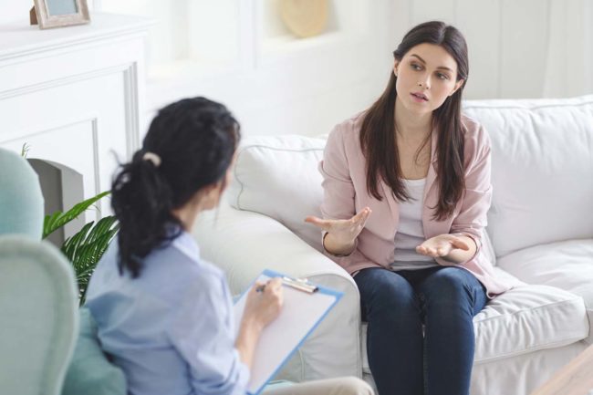 addiction-treatment-for-women a woman talks to her therapist about eating disorder treatment for women