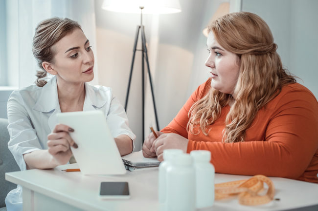 a woman discusses the eating disorder definition with her doctor