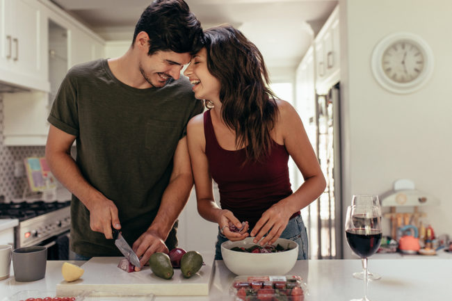 a man and woman cook together as they discuss helping your loved one in recovery