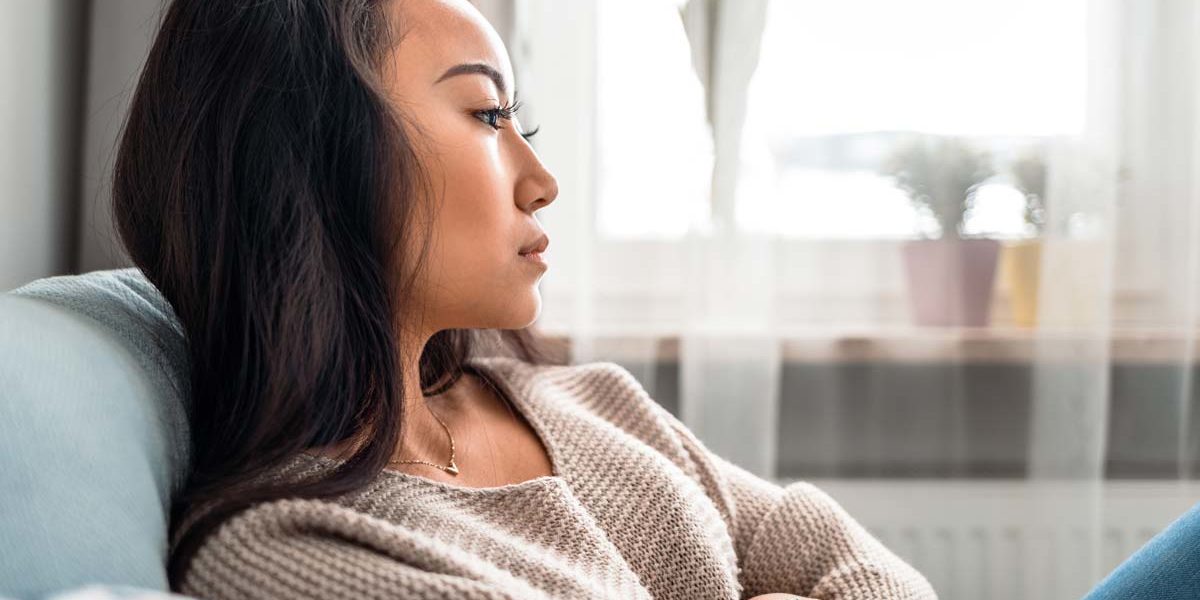 a woman crosses her arms as she thinks about eating disorders in women