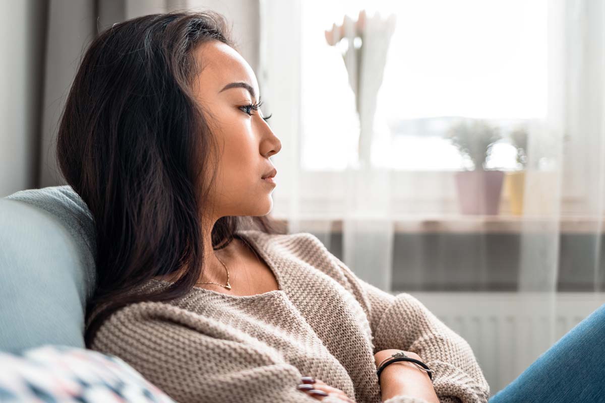 a woman crosses her arms as she thinks about eating disorders in women