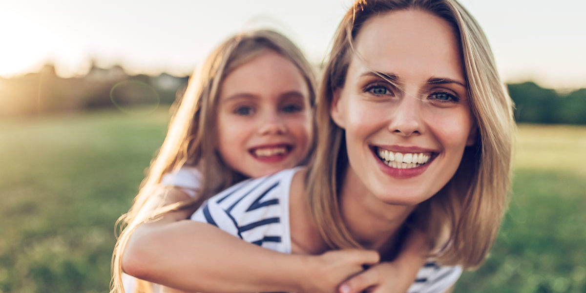 woman and daughter happy after mom learns how to manage her stress and addiction