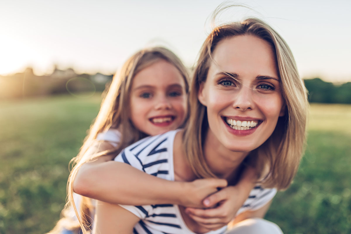 woman and daughter happy after mom learns how to manage her stress and addiction