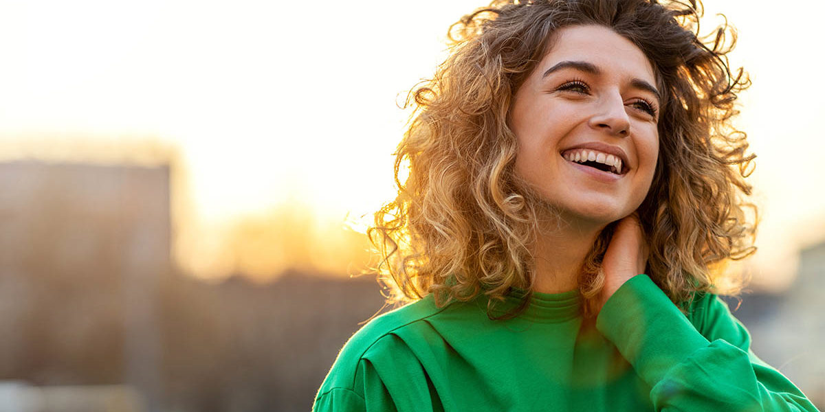 woman happy after learning about women and eating disorders and receiving treatment