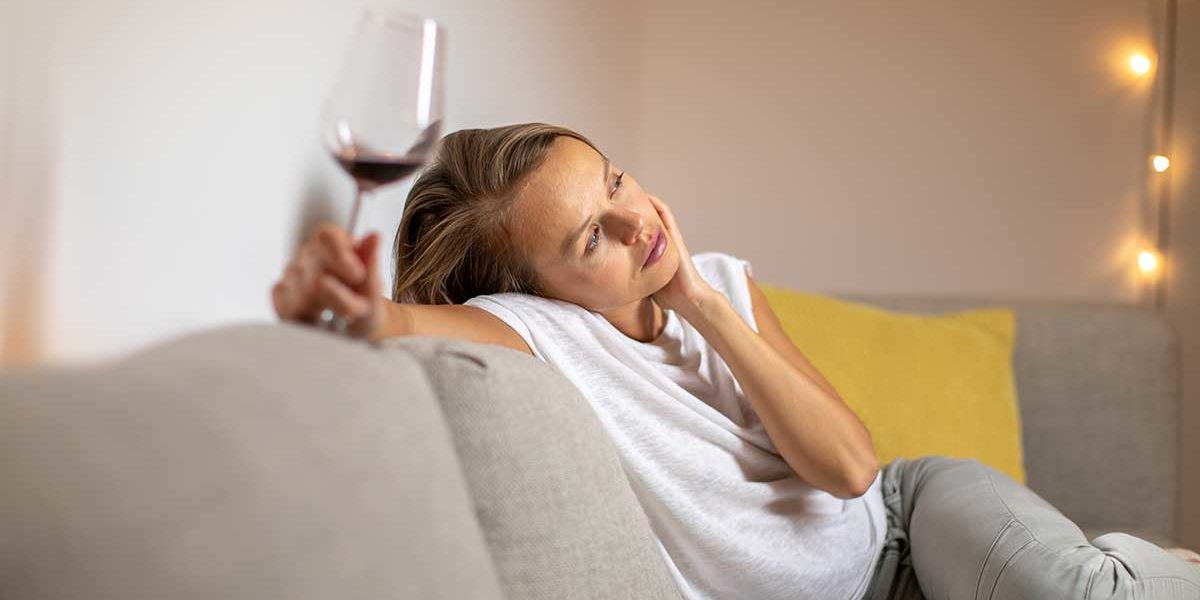woman struggling with alcohol addiction due to life events