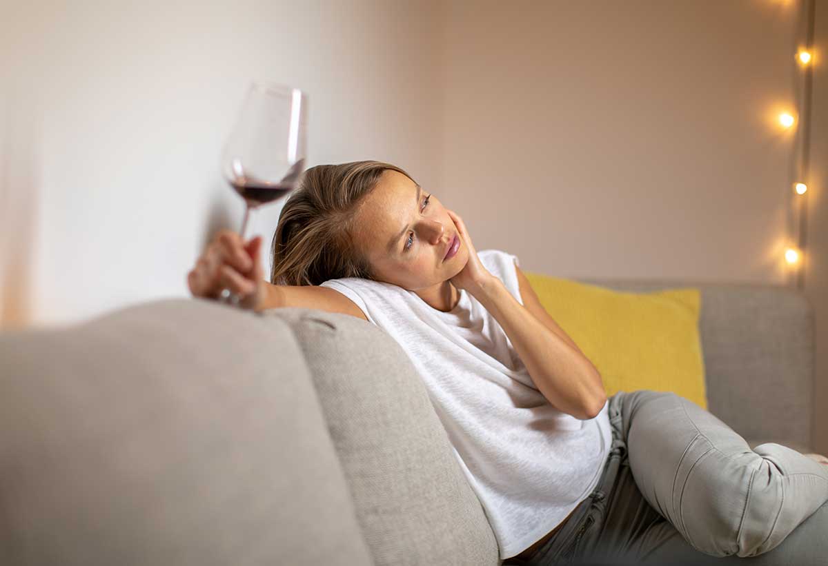 woman struggling with alcohol addiction due to life events