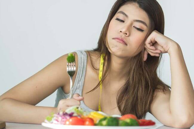 Young Woman Experiencing An Eating Disorder