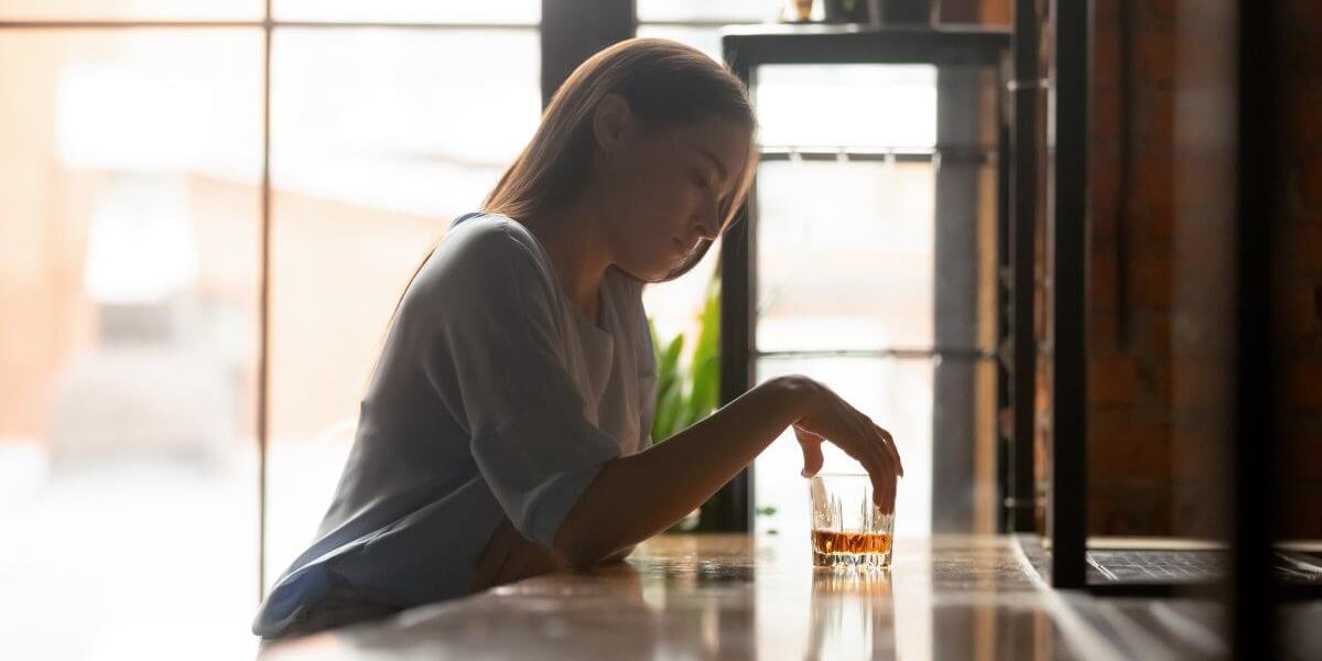 a woman suffers from complications associated with alcohol addiction