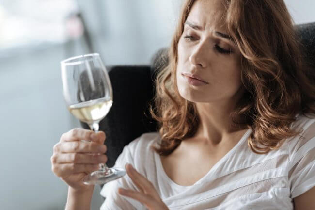 Physical Signs of Alcohol Dependence a woman deals with the physical signs of alcohol dependence