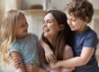 a woman plays with her children after attending a rehab for women with children