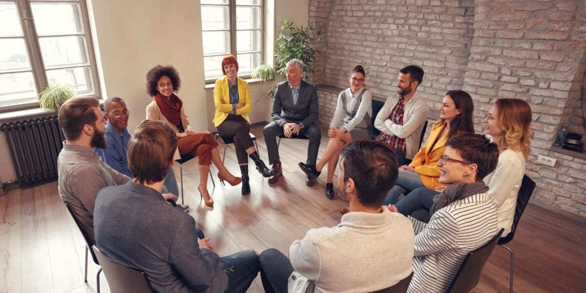 a group of people discuss what is group therapy like