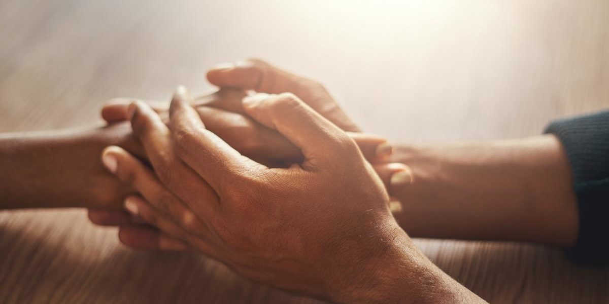 two people holding hands learning how to help someone with anxiety