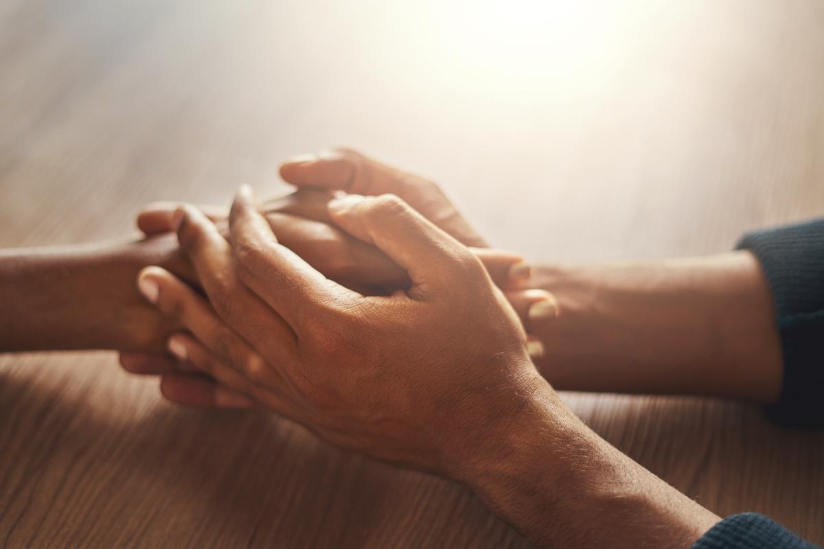 two people holding hands learning how to help someone with anxiety