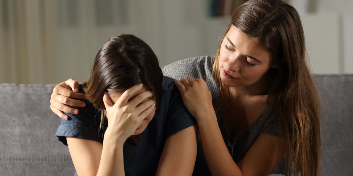 a woman consoling her woman friend and demonstrating how to help someone with bipolar disorder