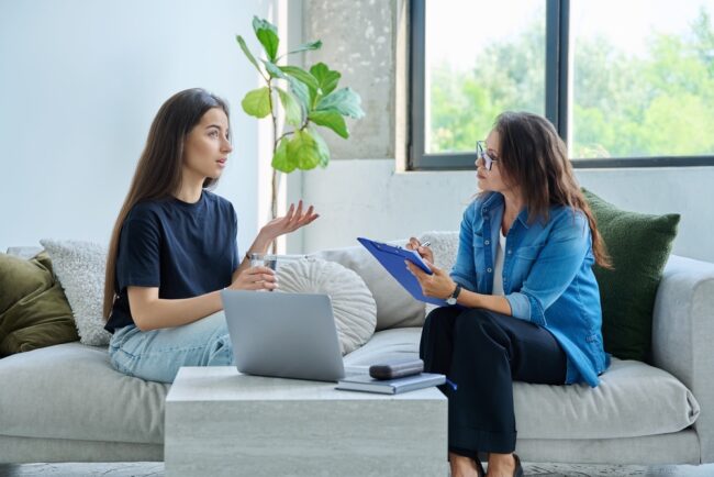 Teenage,Girl,Patient,In,Therapy,Session,With,Social,Mental,Therapist